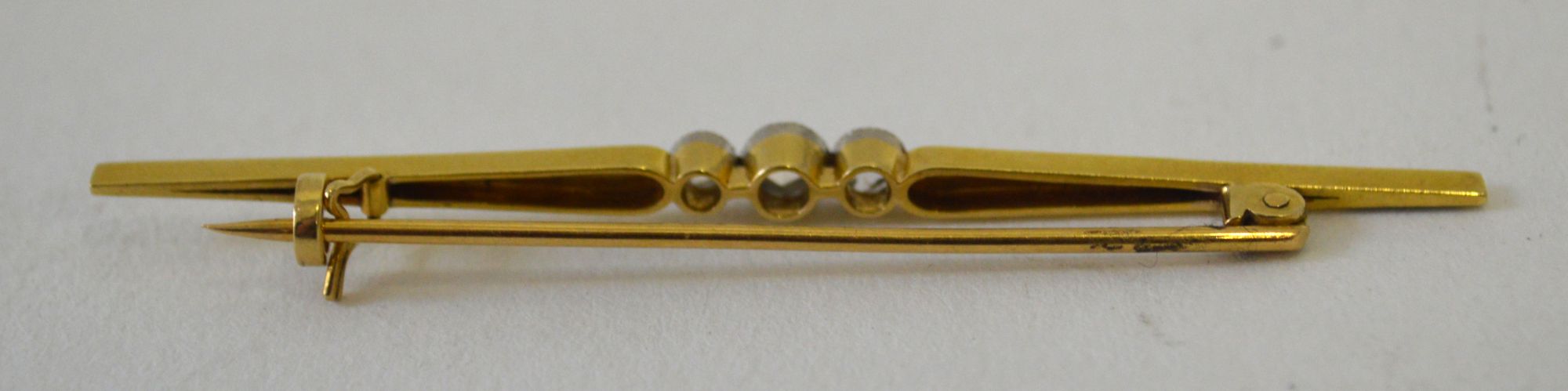 A late 19th century unmarked gold bar brooch, set with three rose cut diamonds, approx 6.5cm. - Image 2 of 2