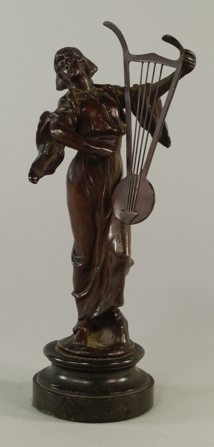 A French bronze model of a girl playing a lyre, late 19th century, on a marble socle, 20.5cm high