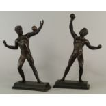 Two bronzed metal models of athletes, mid/late 20th century, each balancing gymnastic balls, on