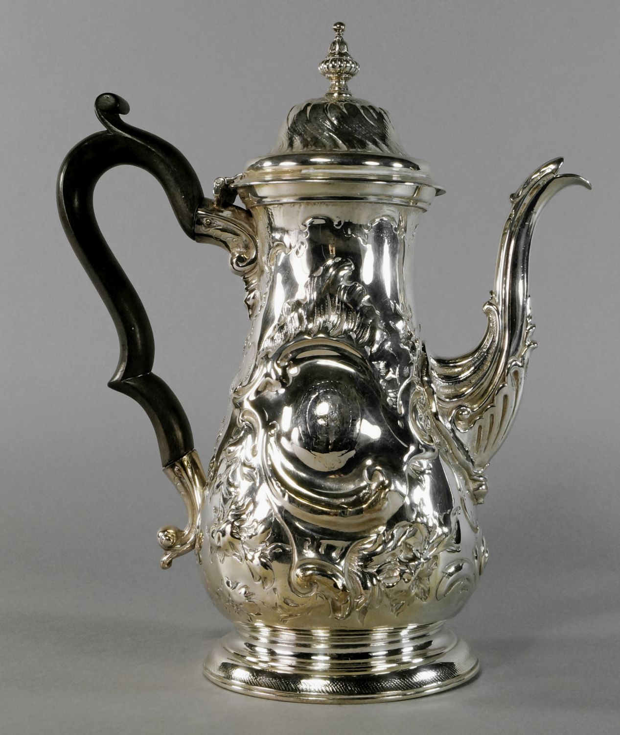 A George III silver coffee pot, London c.1763, Fuller White, of baluster form, with chased rococo