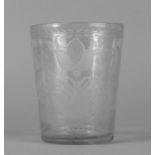A large glass beaker, 19th century, cut with an armorial device to the front and a band of flowers