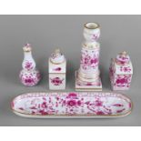 A Meissen porcelain dressing table set, late 19th century, painted and decorated with puce flowers,