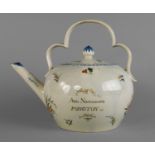 An English cream ware teapot, early 19th century, with shaped handle and elongated spout,