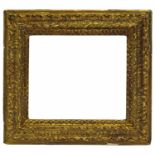 A Bolognese Carved and Gilded Frame, 17th century, with schematic leaf sight, ribbon torus,
