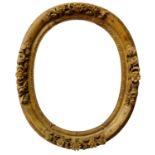 A French Carved Louis XIV Style Oval Lebrun Frame, mid 18th century, with lapped leaf sight,