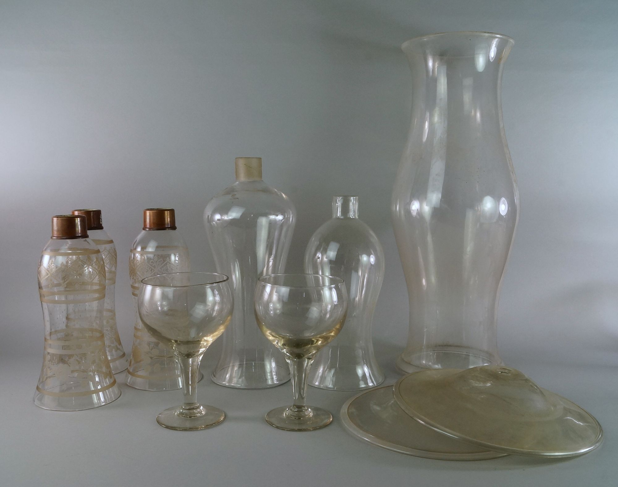 A pair of large drinking glasses, with faceted stems, on pad bases, 20cm high,
