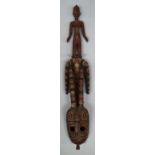 A tribal hardwood carved mask, 20th century, carved with a standing female figure finial,