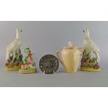 A pair of Staffordshire pottery birds, 19th century, modelled on rocky bases, 26cm high,