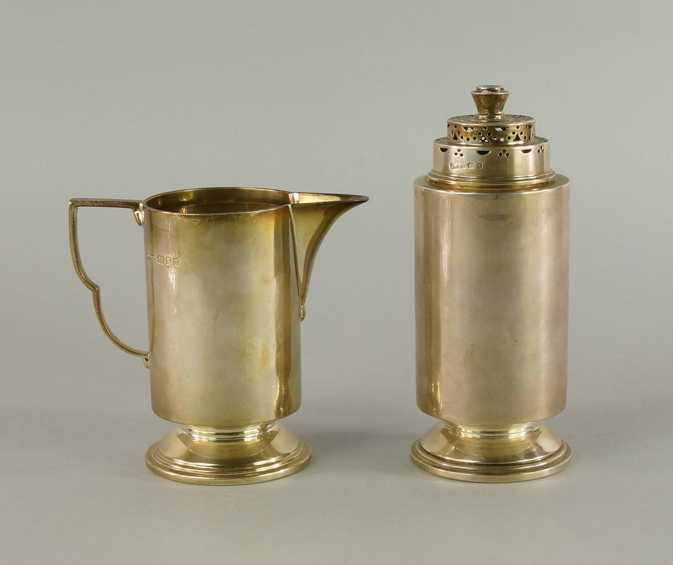 A silver Art Deco sugar caster and matching milk/cream jug, London c.1935, J. W.