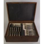 An oak cased part canteen of silver plated cutlery,