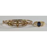 A sapphire and diamond ring, the step cut sapphire collet set to either end,