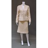 Chanel Boutique: a cream ribbed wool suit, the collarless jacket with four buttoned pockets,