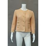 Chanel couture: a peach wool boucle short collarless jacket,