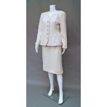 Chanel Boutique: a cream wool boucle skirt and jacket suit the collarless jacket with button