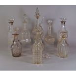 A pair of silver collared decanters, with associated stoppers, 28cm high,