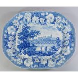 A large blue and white meat plate, 19th century, transfer decorated with a river landscape scene,