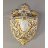 A Victorian porcelain pierced wall pocket, moulded with a female mask ,