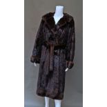 A full length belted mink coat, by Golanski, London, shawl collar and turn-back cuffs,