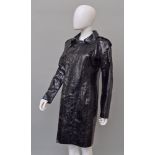 Emilio Pucci: a black python skin coat, concealed double breasted popper fastening,