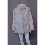 A Saga Fox: a pieced blue fox fur jacket, concealed edge to edge fastening and side pockets,