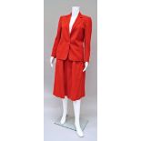 Christian Dior: A tomato red wool skirt and jacket suit, the jacket with single button,