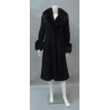 An Italian black knit and faux Persian lamb full length coat, by The Eurofur,