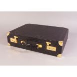 A black ostrich skin attaché case, with gilt metal hardware and combination locks,