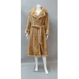 A full length pastel mink coat, with collar and reveres, flared cuffs with fancy buttons,