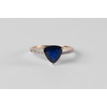 An 18ct gold and Burmese sapphire ring, the trilliant cut sapphire approx 1.