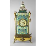 A gilt metal and enamel clock, mid 20th century, mounted with an urn finial on a square domed top.