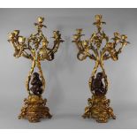 A pair of gilt bronze and patinated bronze seven light candelabra, late 19th century,