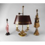 A gilt metal bouillotte lamp, 20th century, with a red lacquered metal fall and rise shade,