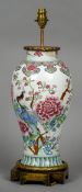 A Chinese porcelain baluster vase
Decorated with exotic birds amongst floral sprays interspersed