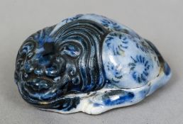 A Chinese blue and white porcelain box and cover
Modelled as a temple dog,