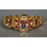 An unmarked high carat gold, ruby, clear sapphire and enamel set bracelet
17.5 cm long.