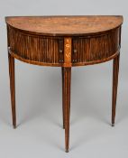 A 19th century Dutch marquetry inlaid demi-lune card table
The hinged top enclosing a baize lined