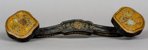 A Chinese lacquered wood ruyi sceptre
Decorated with floral vignettes,