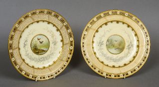 A pair of 19th century painted and gilt decorated porcelain plates
Each decorated to the centre