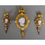 A 19th century unmarked gold enamel decorated hardstone cameo suite
Comprising: a pendant brooch