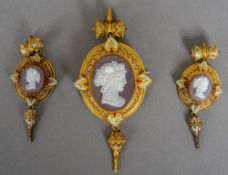 A 19th century unmarked gold enamel decorated hardstone cameo suite
Comprising: a pendant brooch