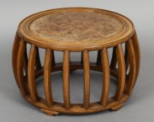 A Chinese barrel form low centre table
The moulded circular top centred with a burrwood panel above