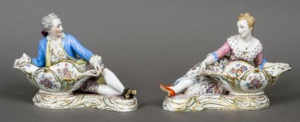 A pair of 19th century Dresden porcelain sweetmeat dishes
Modelled as reclining man and woman with