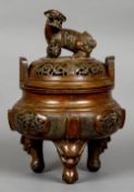 A large Chinese bronze censor
The pierced lid mounted with a dog-of-fo,