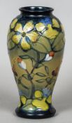 A Moorcroft pottery vase
With tube lined floral decoration, variously marked to base.  25.5 cm high.