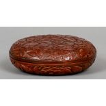 A Chinese red lacquer circular box and cover
Worked with floral sprays.  17 cm diameter.