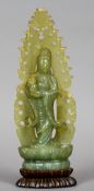 A Chinese carved jade model of Guanyin
Modelled holding a bottle vase,