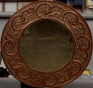 An Arts & Crafts copper framed wall glass
The bevelled circular plate within a broad frame worked