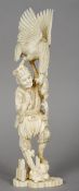 A Japanese ivory okimono formed as a fisherman
Surmounted with an eagle stealing his catch.  37.