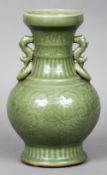 A large Chinese celadon vase
Of ovoid form with twin dolphin and ring handles,