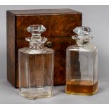 A 19th century burr walnut decanter box
The rectangular hinged cover enclosing a pair of cut glass
